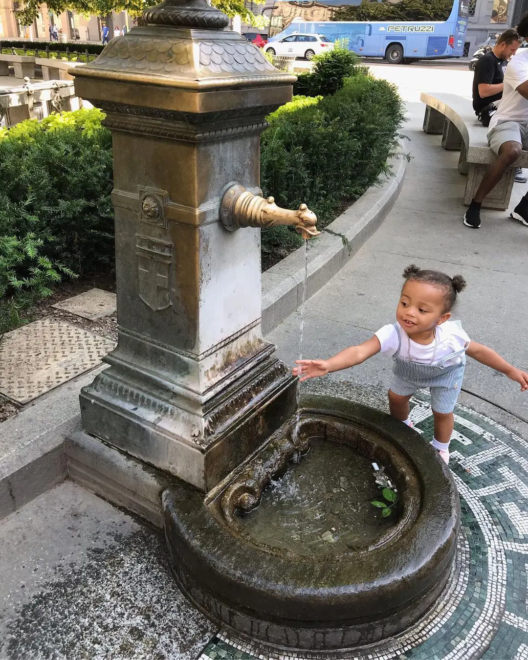 Rainer playing with water fountain on her vacation in Milan