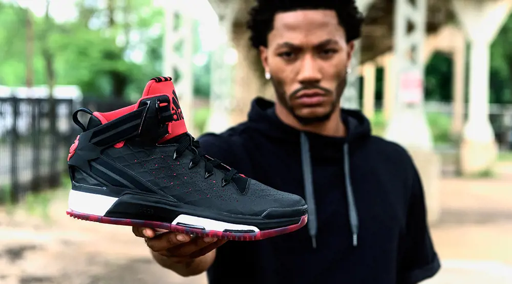 NBA player Derrick holding his newest release, D Rose 6, in the fall of 2015.