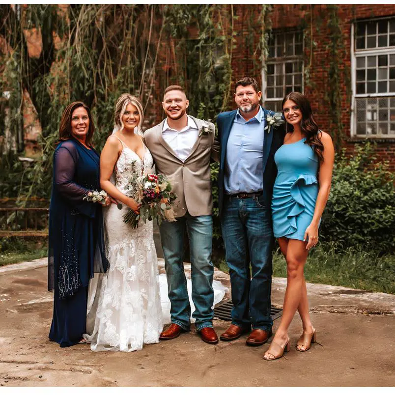 Sydney with her family during her brother's wedding in July 2022