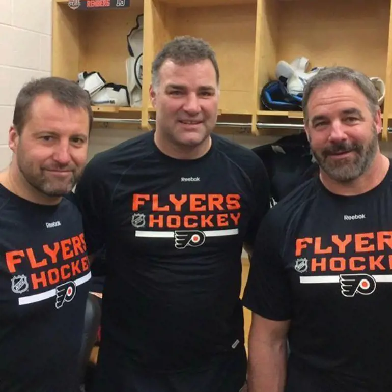 Eric with his hockey teammate John LeClair and Mikael Renberg.