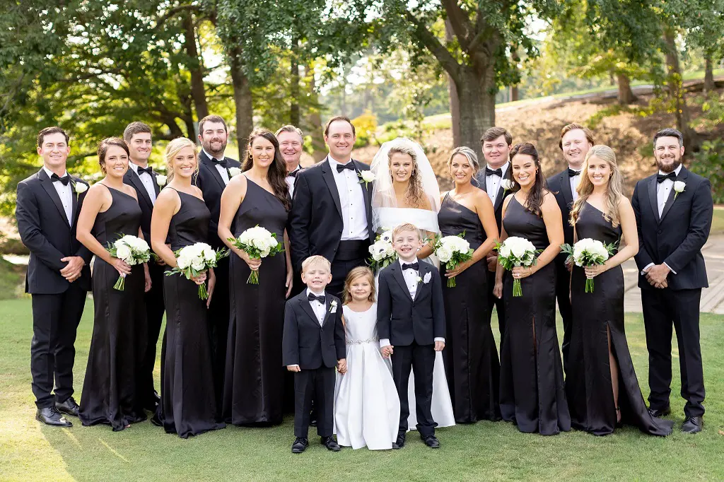 The bridesmaid and groomsmen dressed in black and white attire for Paige and Sepp's marriage.