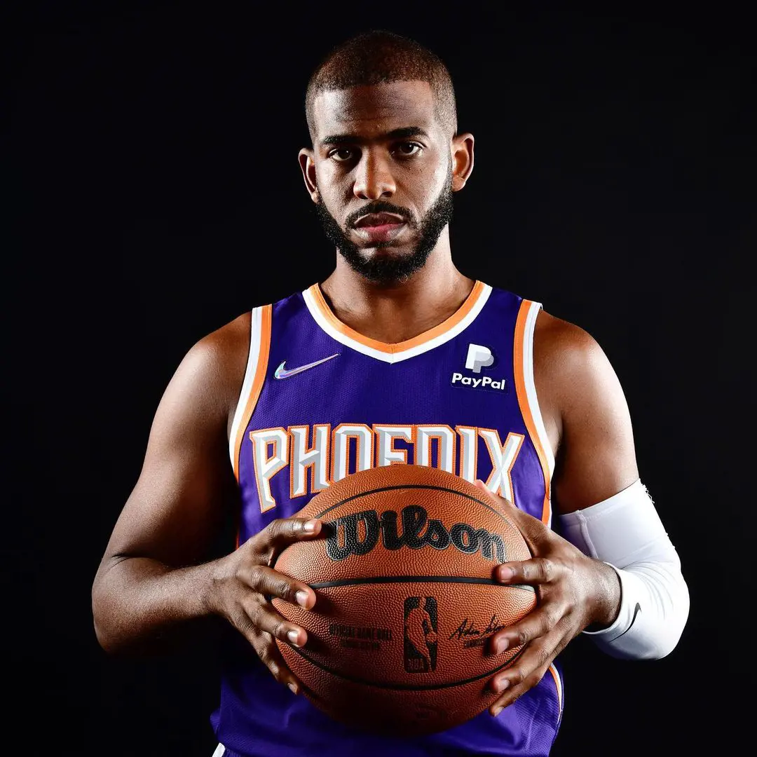 Chris Paul poses for a portrait with Wilson basketball while donning a Phoenix Nike brand jersey