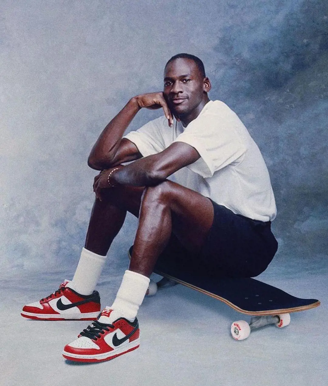 Jordan shows off his Nike sneakers while posing for a photo while sitting on a skateboard