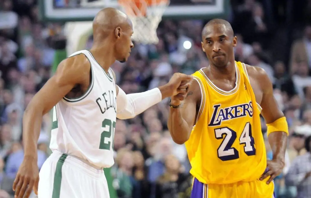Kobe with his opponent during his basketball game.