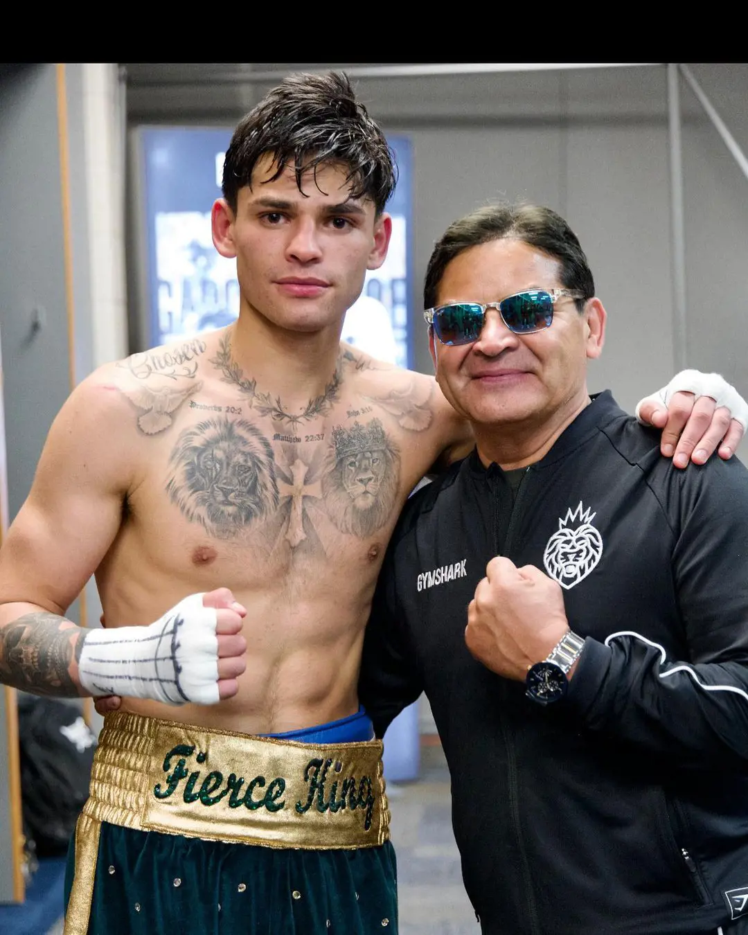 Garcia shows off his lion tattoos as his father, Henry, wears a lion branded jacket
