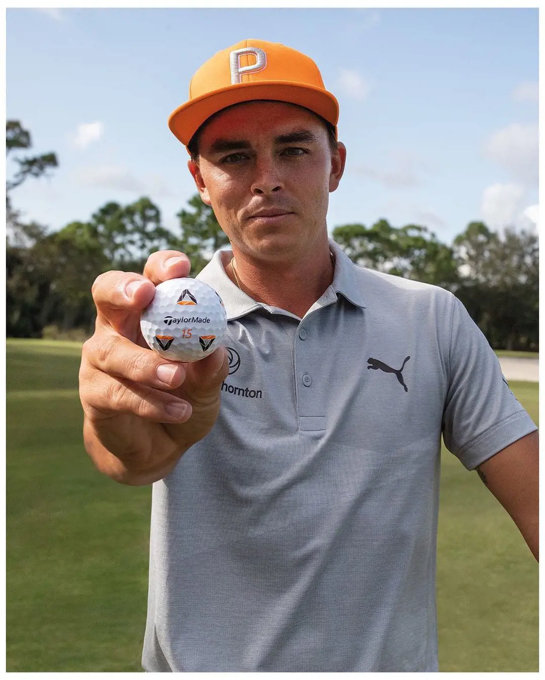 Rickie Fowler wearing grey Polo t-shirt by Puma and cap with the capital P which also stands for Puma in February 2020