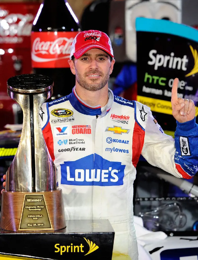 Johnson poses with the NASCAR Sprint Cup Series trophy on May 25, 2014. (Photo by Jared C. Tilton)