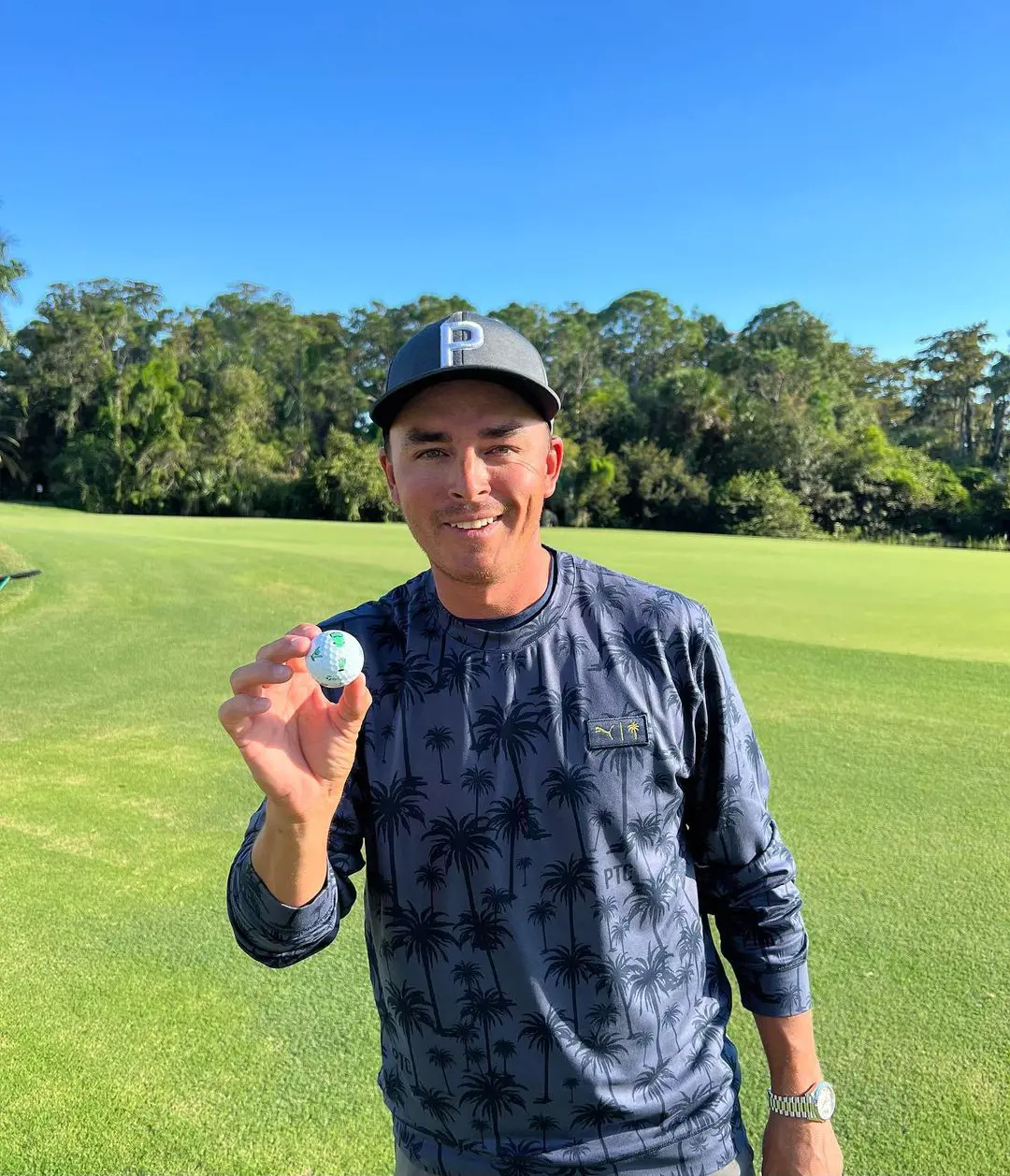 Rickie showing off Taylormade TP5 pix golf ball. 