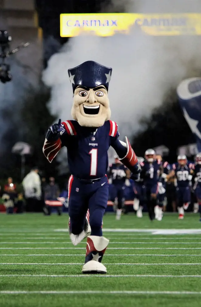 The Patriots talisman running in the filed ahead of the match in March 2023.