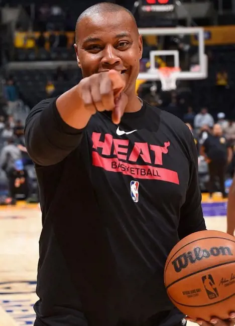 Caron wearing Heat Basketball t-shirt holding ball on his hand. 